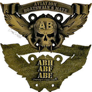 Gold-tone challenge coin. Features an aviation boatswain's mate emblem