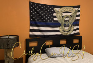 Thin Blue Line flag with "MOTOR OFFICER" text and a badge design. Blue, black, and white colors on a dark brown background.