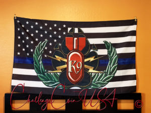 Thin Blue Line flag with a bomb and K9 emblem. White stars on blue field, black stripes. Cotton material. Challenge Coin USA