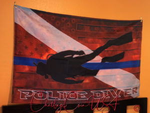 Thin Blue Line flag. Black diver silhouette against blue and red stripes. White stars visible. 3x5 feet. Challenge Coin USA