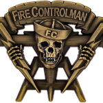 Gold-tone challenge coin. Features a Fire Controlman skull with crossed tools