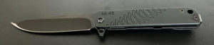 Closed Medford M48 knife. Black titanium handle with a partially visible yellow insert.