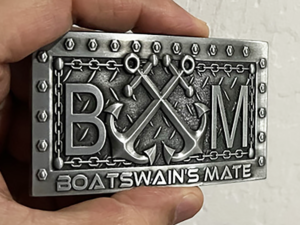 Silver-tone belt buckle. Features crossed anchor and rope design. "Boatswain's Mate