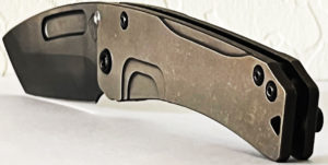 Bronze handle of a Medford Slim Midi knife. Visible pivot
