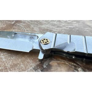 Medford USMC Fighter flipper knife. Gray titanium handle with a gold coin inset.