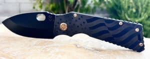 Black Medford TFF1 Tactical Fighting Folder knife. Features a US flag