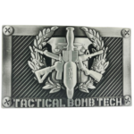 Silver-tone belt buckle. Features bomb technician design with crossed rifles, laurel wreath, and tools. Raised relief.